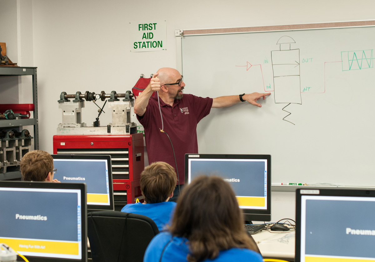 JJC Technical Professor Dr. Jeff Bradford at white board during Technology Camp