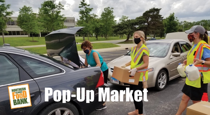 volunteers loading food into cars